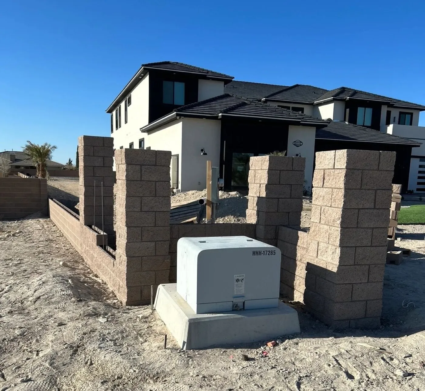 Split face block wall with pilasters going up at a new Las Vegas home, rebar standing in the open cells