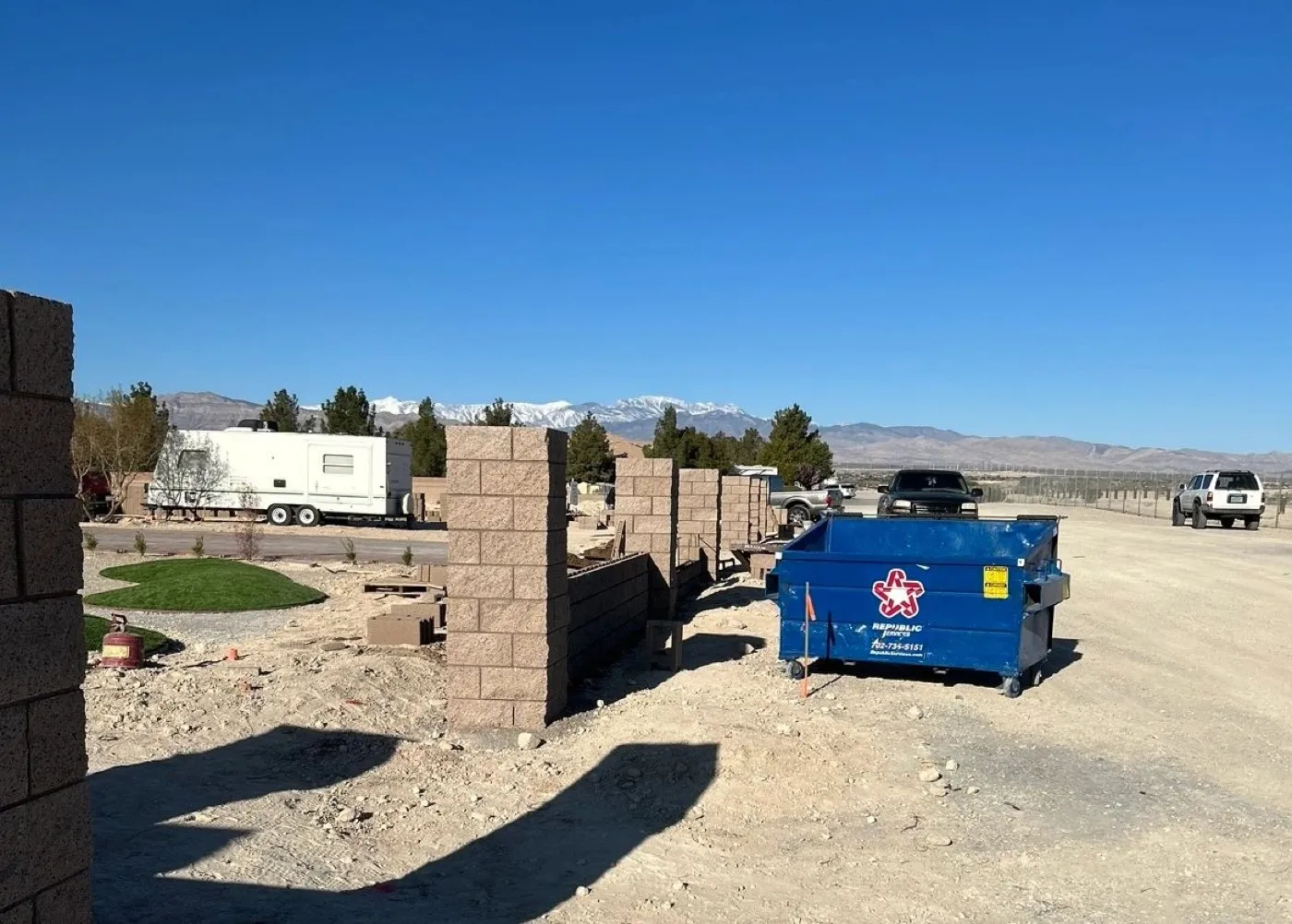 Block wall going up course by course on a valley lot