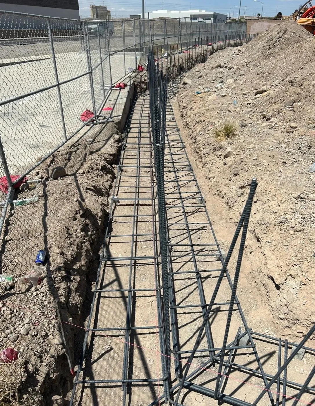Vertical rebar dowels set along a block wall footing on a Las Vegas job