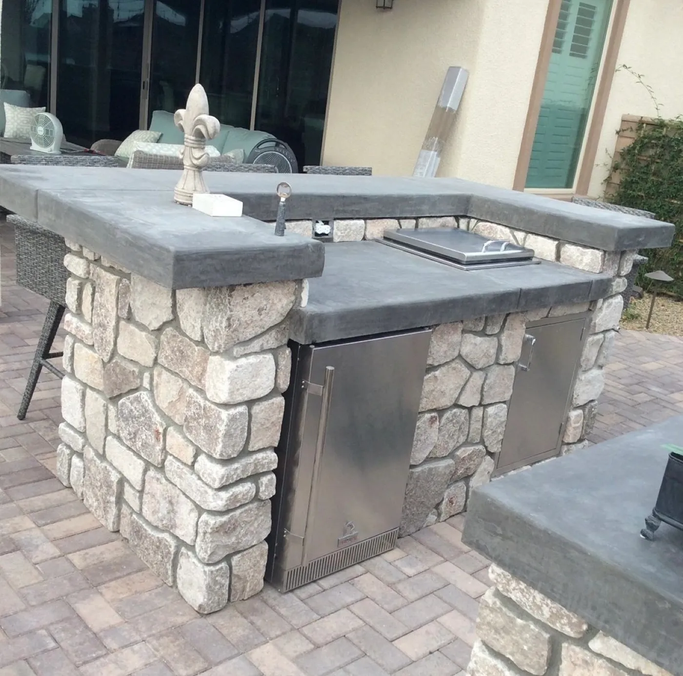 Custom block BBQ island faced in stone with a granite counter